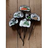 A set of six painted cast iron vegetable labels