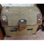 A vintage canvas dome-top travelling trunk with leather bound corners, strapping and flanking