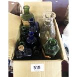 A box containing a small quantity of old glass bottles including blue and green poison bottles,