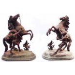 A pair of 19th Century spelter Marley horse figurines set on wooden plinths