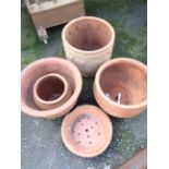 Four large terracotta pots and a bulb saucer