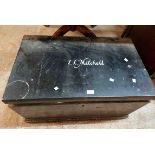 An 84cm black painted pine lift-top box with name to top 'I. L. Mitchell'