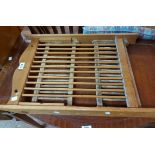 A small pine folding two shelf open plate rack