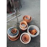 A quantity of garden pots and a metal plant holder