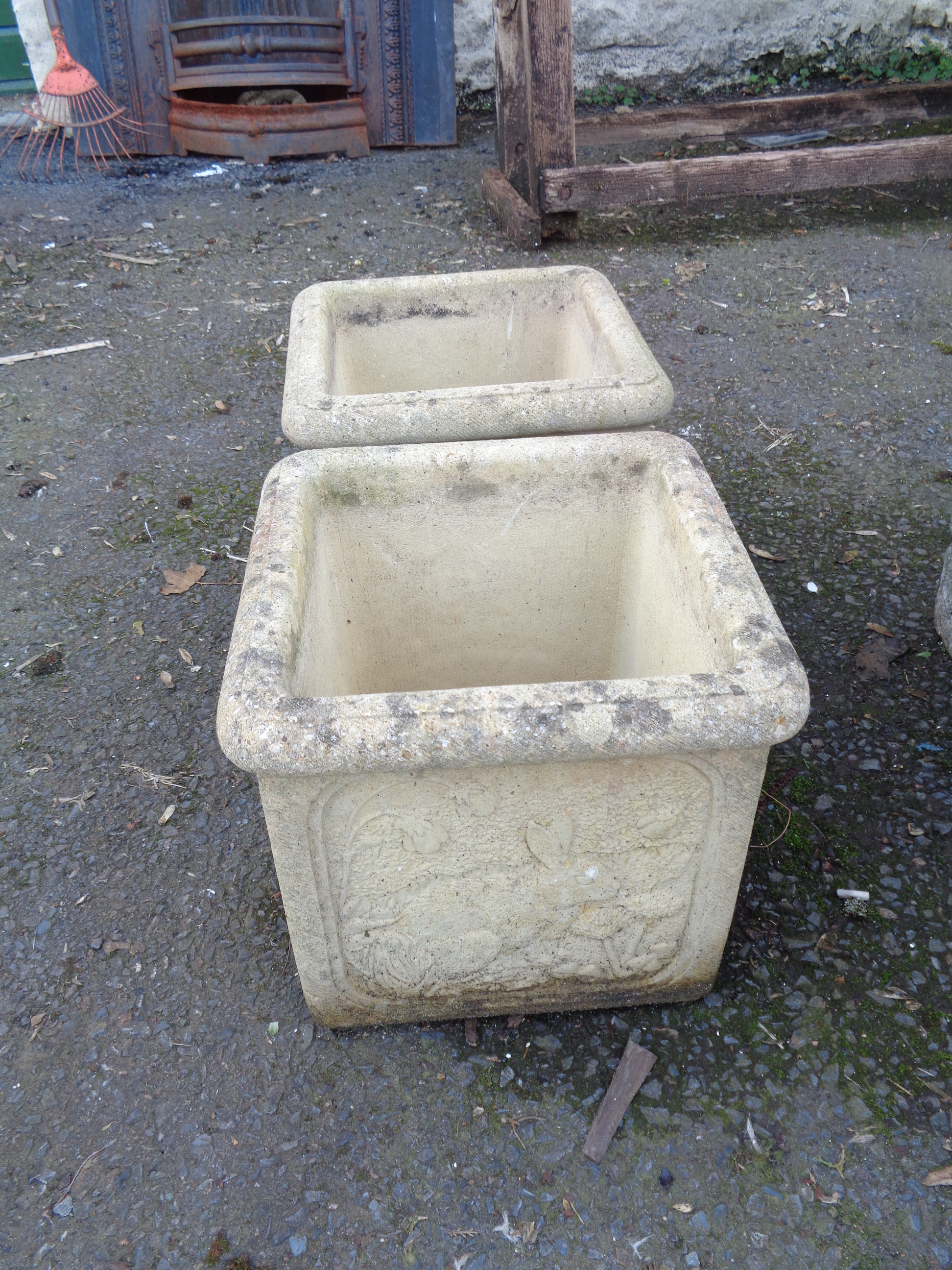 A pair of concrete garden planters of square form with moulded rabbit decoration