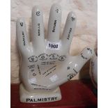 A modern palmistry hand with black lettering on a crackle glaze ground