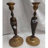 A pair of Victorian cast brass figural candlesticks, each depicting a classical maiden