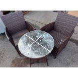 A modern Chelsea Garden Co. rattan effect garden furniture set comprising circular glass topped