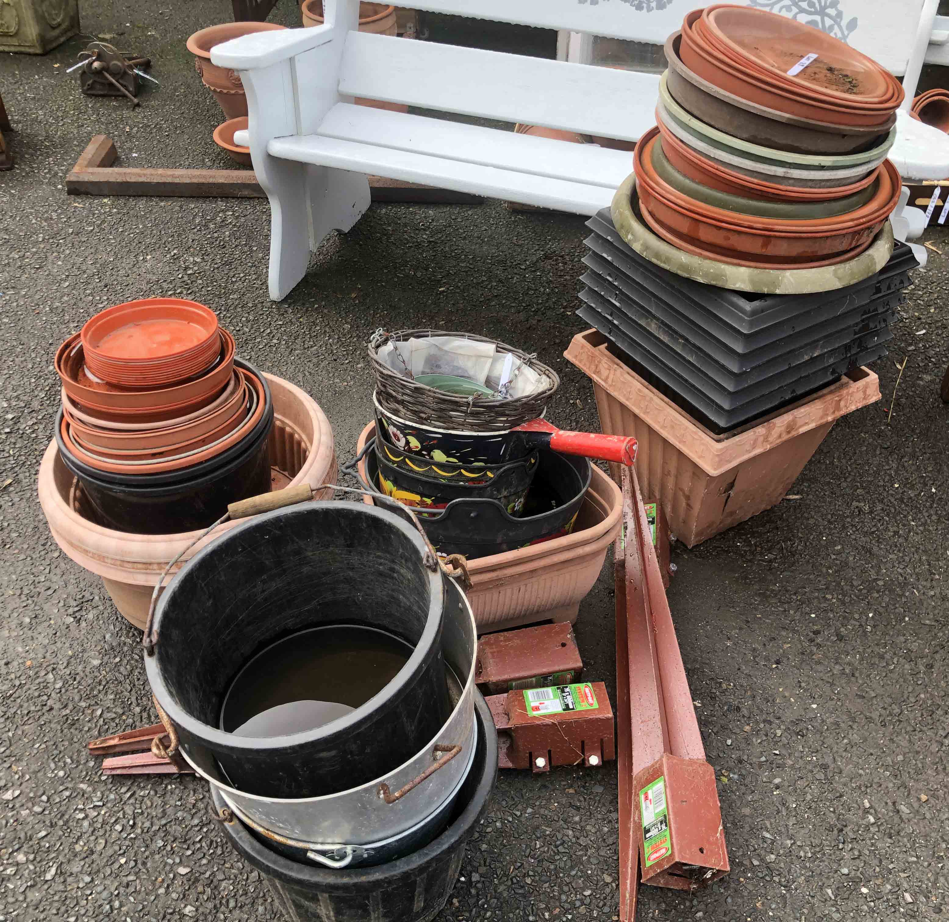 A large quantity of plastic garden pots and planters