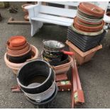 A large quantity of plastic garden pots and planters