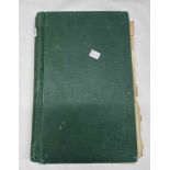 A green student's lined page folder containing handwritten text and diagrams relating to
