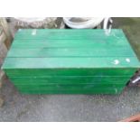 A green painted lift-top wooden trunk