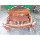 A cast iron fire basket of classical form with brass urn finials