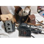 A small selection of vintage cameras including Kodak Vest camera, Polaroid land camera, etc.
