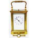 An old brass and bevelled glass cased EGL carriage clock with Arabic numerals and strike/repeat