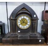 A 49cm late Victorian black slate mitre shaped mantel clock with visible escapement and S. Marti '