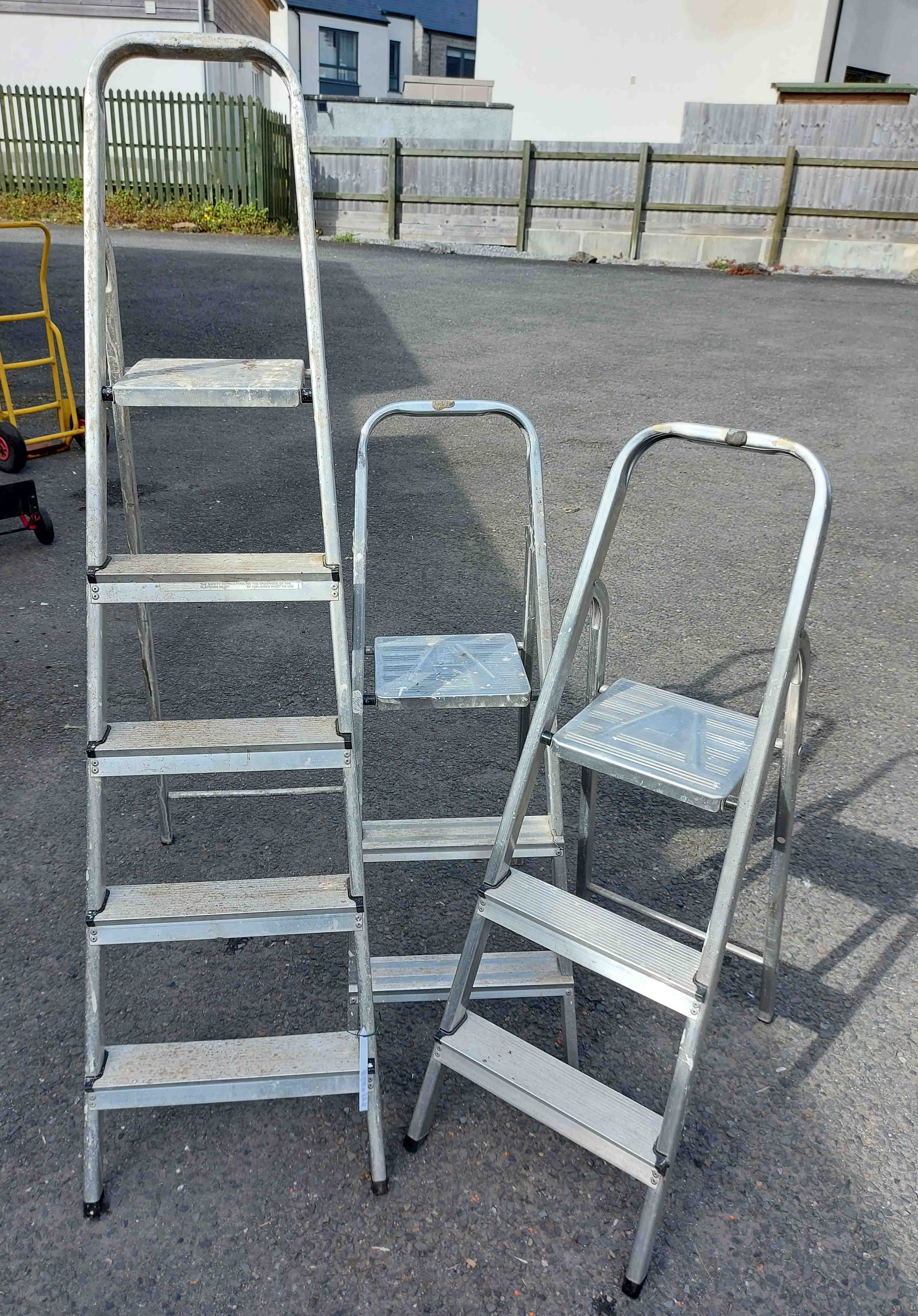 Three aluminium stepladders