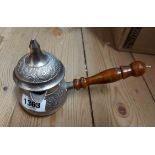 A small silver plated Arabic coffee pot with chased decoration and turned wooden handle