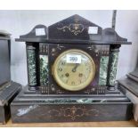 A late Victorian black slate and green marble cased mantel clock of architectural design with
