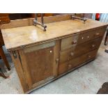 A 1.55m Victorian pine dresser base with low raised back, wide fold-over top with flanking lopers,