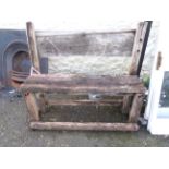 A rustic style oak garden bench of plank form