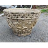 A concrete garden planter of round bowl form, with moulded swag decoration