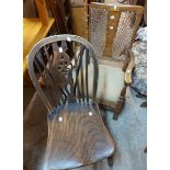 An early 20th Century walnut and mixed wood nursing chair with decorative rattan panel back and