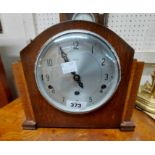 A mid 20th Century stained oak cased mantel clock with Enfield eight day chiming movement - sold