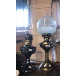 An Aladdin oil lamp with plated finish and glass chimney - sold with a brass similar with etched and