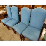 A set of four reproduction high back dining chairs with blue upholstery, set on polished wood legs