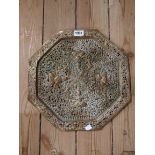 An Indian pierced brass tray with embossed figural decoration