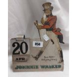 A vintage pressed tin Johnny Walker advertising calendar