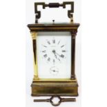 An antique French brass and bevelled glass cased carriage clock with columns to corners and L'Epee