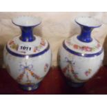 A pair of Edwardian continental porcelain vases of rounded form with transfer printed floral