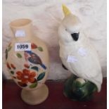 A ceramic model depicting a cockatoo seated on a branch - sold with a Victorian opaque glass vase