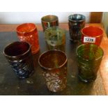 Eight Carnival glass tumblers of various colour and design