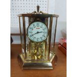 A Kundo faceted cased anniversary clock with ball pendulum and battery movement