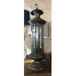 A vintage brass table lantern of cylindrical form with bevelled and cut glass panels enclosing a