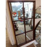 A modern stained wood framed oblong wall mirror with chamfered beading to plate