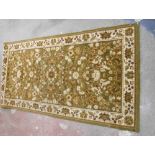 A modern Diplomat machine made Belgium rug with Persian style profuse decoration on green ground -