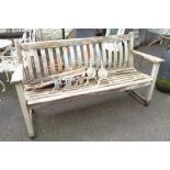 A 1.5m weathered teak lathe back garden bench with slatted seat and flanking armrests - by Alexander