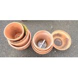 Eleven terracotta plant pots of varying size