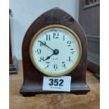 A small antique American mitre shaped timepiece with Seth Thomas simple thirty hour movement