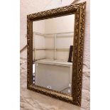 A reproduction ornate gilt resin framed oblong wall mirror with pierced border