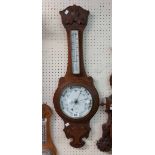 A late Victorian stained oak mounted O. Comitti & Son banjo barometer/thermometer with printed