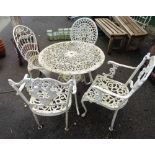 A white painted cast metal patio set in the antique style with ornate pierced decoration -