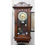 An early 20th Century oak cased Arts & Crafts style Vienna regulator wall clock with applied