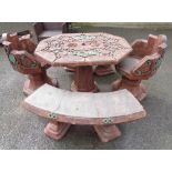 A Chinese style cast concrete gardens set comprising, table, two chairs and two benches with green