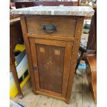 An early 20th Century Arts & Crafts movement oak pot cupboard with marble top and single frieze