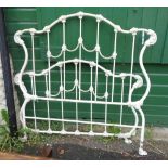 A modern cast iron Laura Ashley bed with decorative scrolling and white painted finish